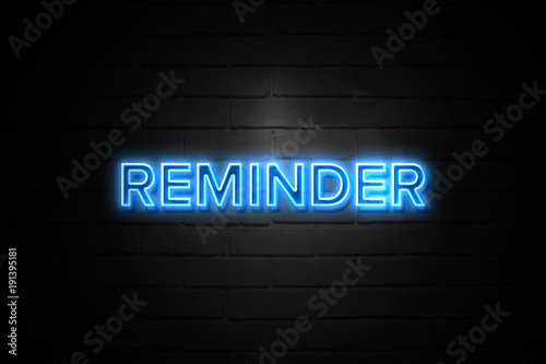 Reminder neon Sign on brickwall