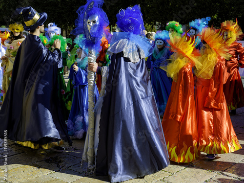 Young people and children with beautiful and colorful clothes during the parade of masked groups in the city streets of a city in Puglia. Italy © peuceta