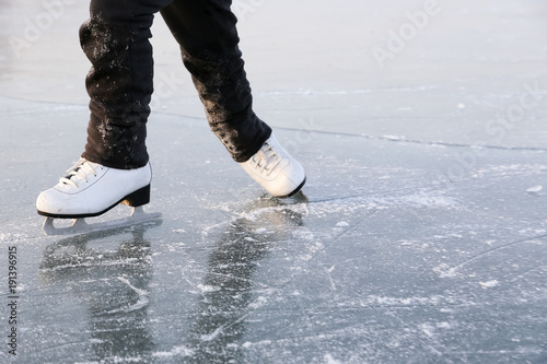 Young woman ice skating outdoors