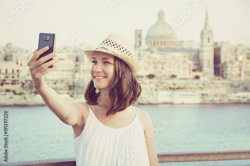 Obraz na płótnie Young woman tourist taking selfie on mobile phone, Valletta - Malta  cityscape