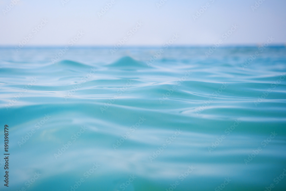 Surface of blue sea water with soft waves and clear sky on horizon. Ocean water background Surface of blue sea water with soft waves and clear sky on horizon. Ocean water background