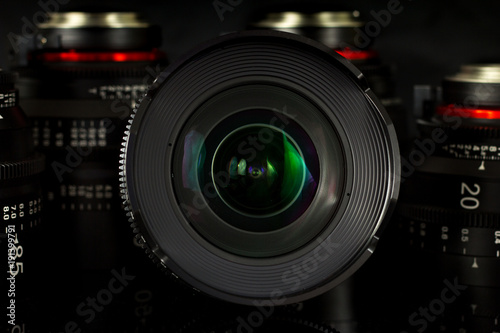 Professional Cinema Lens - concept of camera lenses on the mirroring black background.