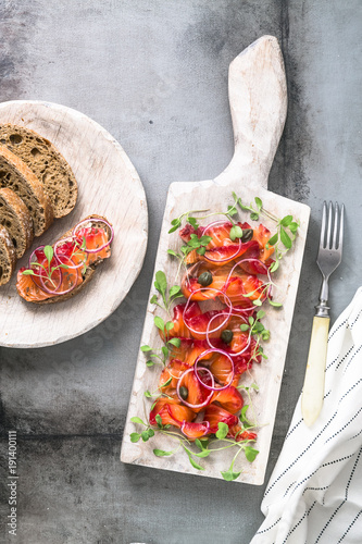 Gravlax - cured salmon or trout with onion and bread photo