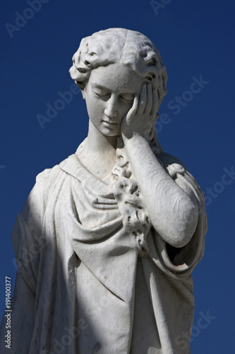 Facepalm statue in front of blue sky