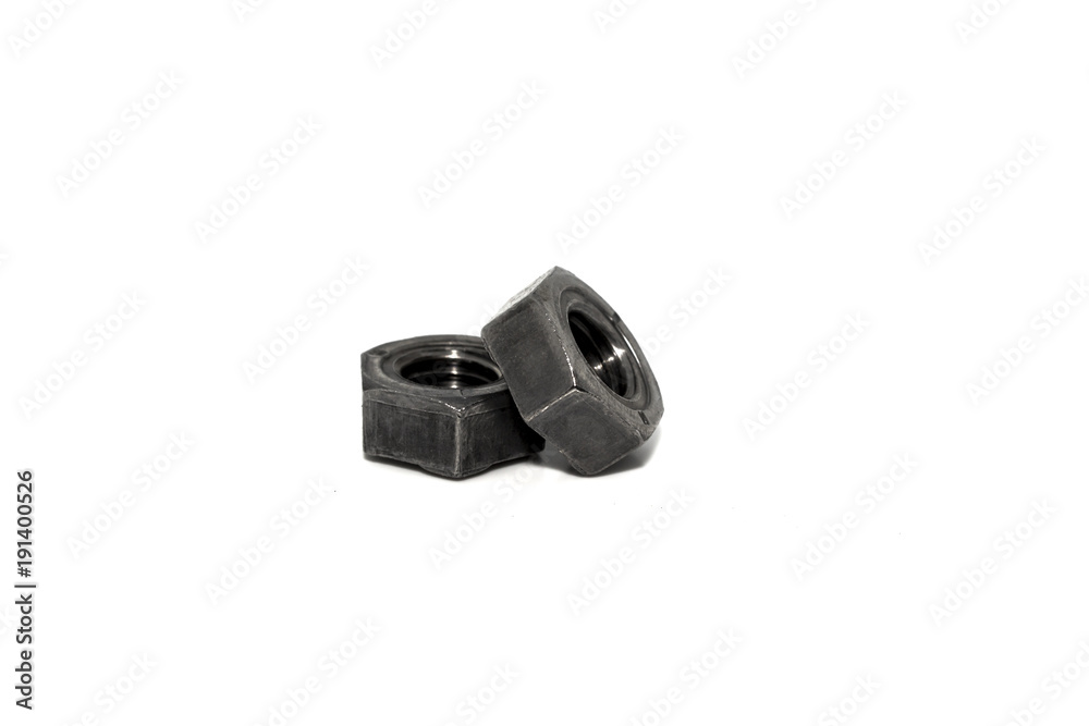 A couple of isolated industrial steel nuts on white background A couple of isolated industrial steel nuts on white background