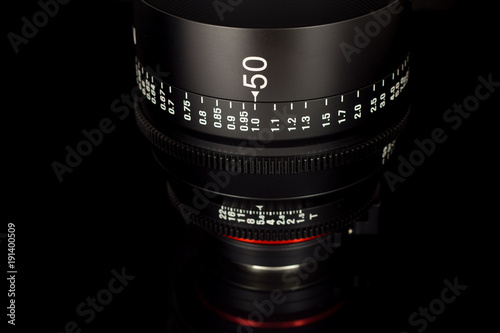 Professional Cinema Lens - concept of camera lenses on the mirroring black background.