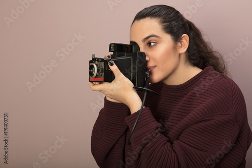 Female photographer focusing on the viewer photo