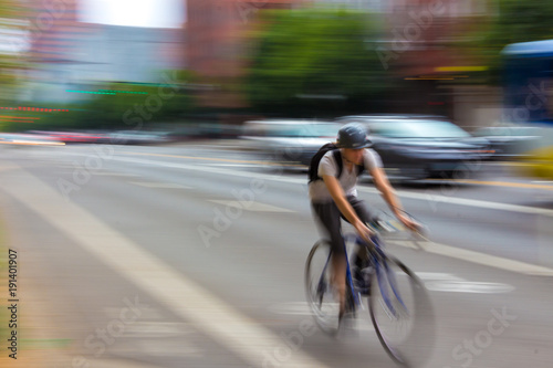Man riding bike on a street blurred. .