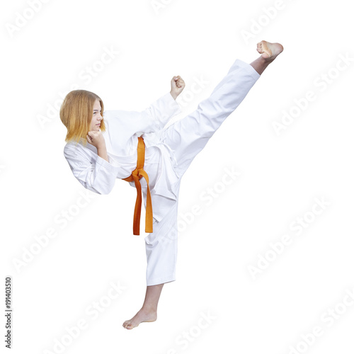 Adult female athlete in karategi is beating blow hand against a white background