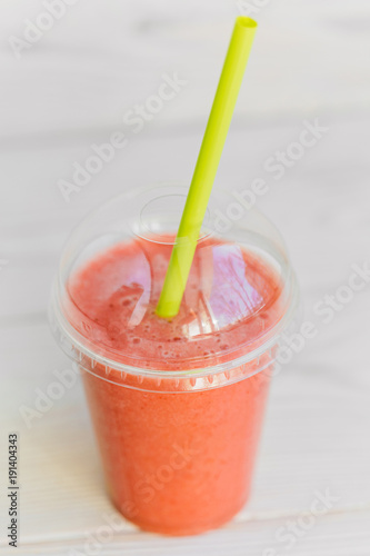 Obraz na płótnie strawberry smoothie in plastic glass 2go with cocktail tube. Healthy apple banana and strawberry blended drink to go. w salonie