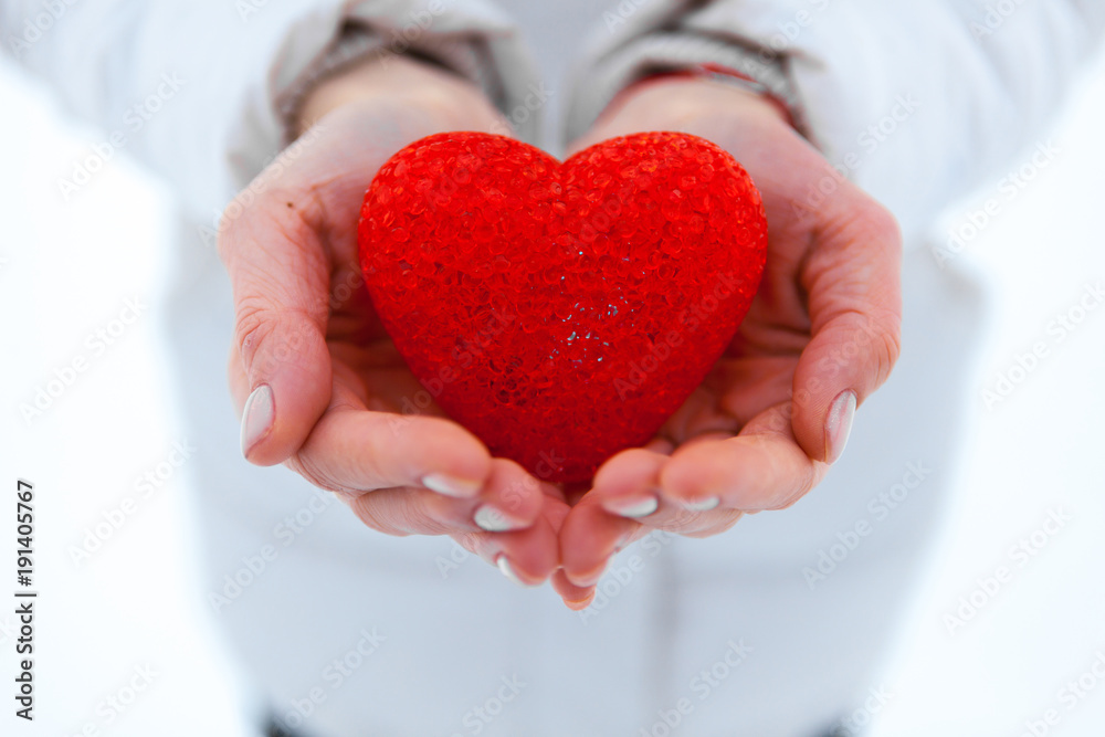 The red textured heart lies on the palms. Valentine's Day. The red textured heart lies on the palms. Valentine's Day.