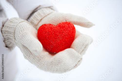 The red textured heart lies on the palms. Valentine s Day.