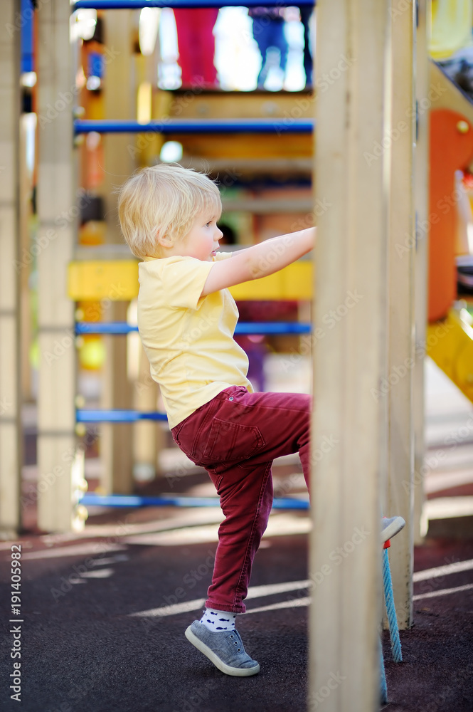 Little boy having fun on outdoor playground Little boy having fun on outdoor playground