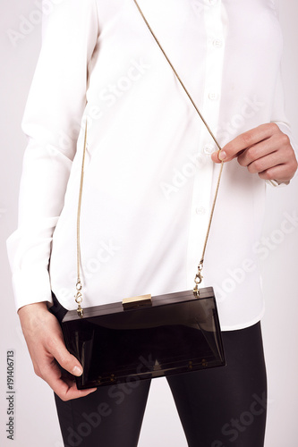 Obraz na płótnie Black Women's handbag in hand, Ladies bag, Black female clutch,Black clutch.Women's bag isolated white background.Bag isolated white background.Clutch isolated white background. w salonie