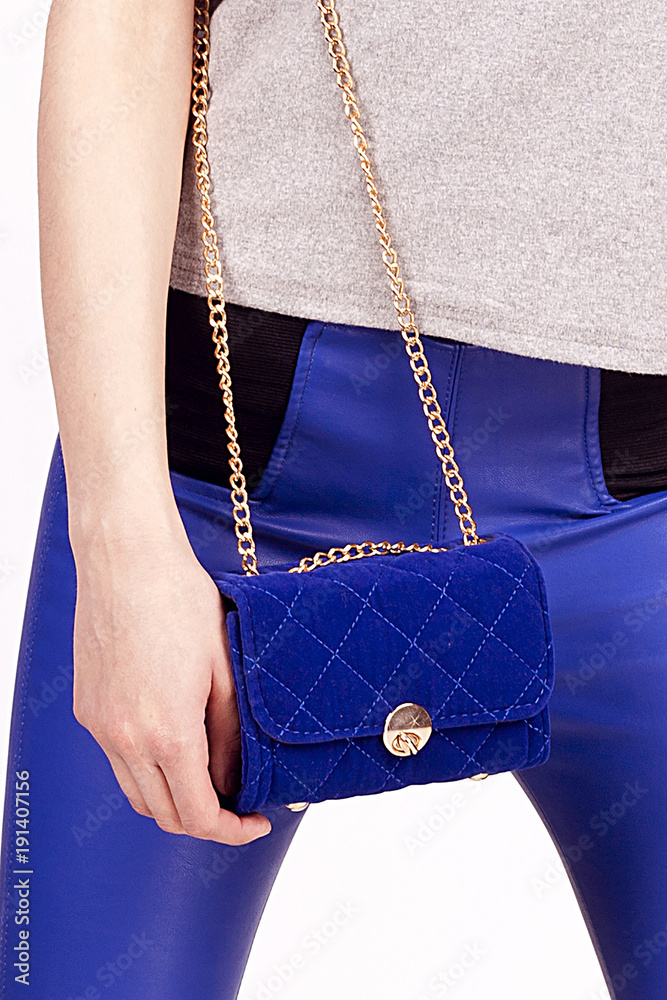 Blue Women's handbag in hand, Ladies bag, Blue female clutch,Blue clutch.Women's bag isolated white background.Bag isolated white background.Clutch isolated white background.