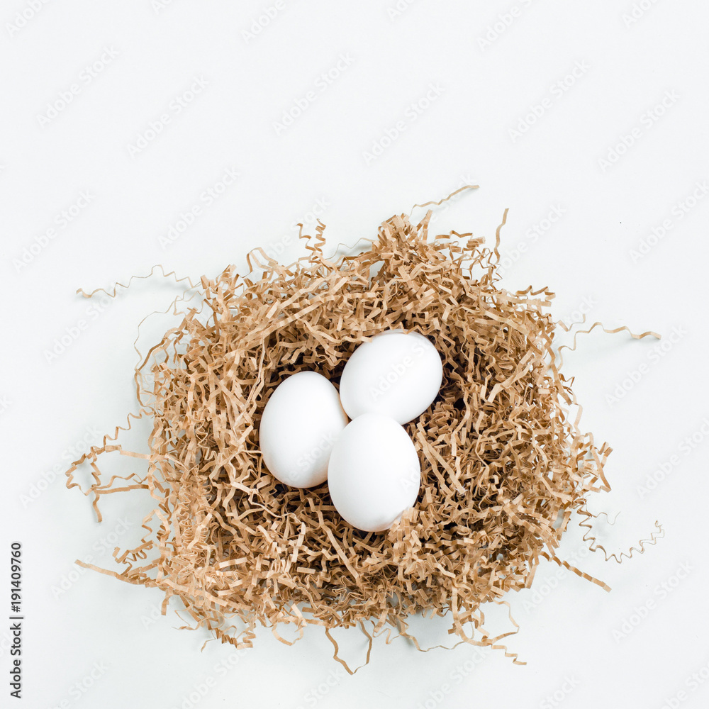 White eggs in the nest on white background. White eggs in the nest on white background.