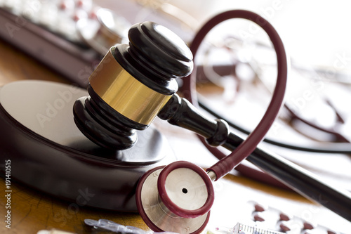 Medicine law concept. Judges gavel with  stethoscope  and pills close up