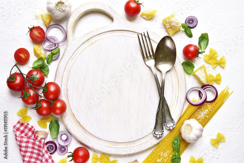 Traditional raw ingredients of mediterranean cuisine and epty cutting board.Top view with space for text.