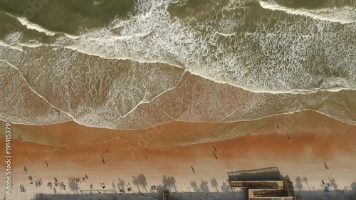 Panning down beach from above