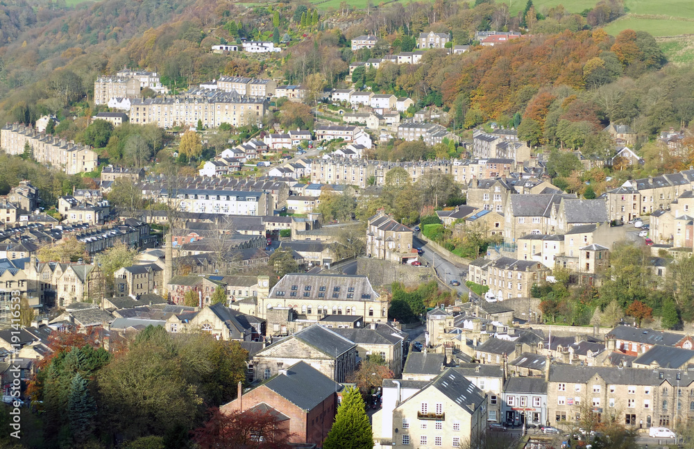 panoramic aerial view of the town of hebden bridge in west yorkshire showing the streets houses and old mill buildings set in the surrounding pennine valley woodland