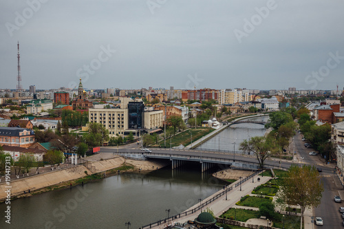 Aerial Astrakhan day cityscape from rooftop. View to bridge through Volga river, historical and modern buildings. Astrakhan downtown © Mulderphoto