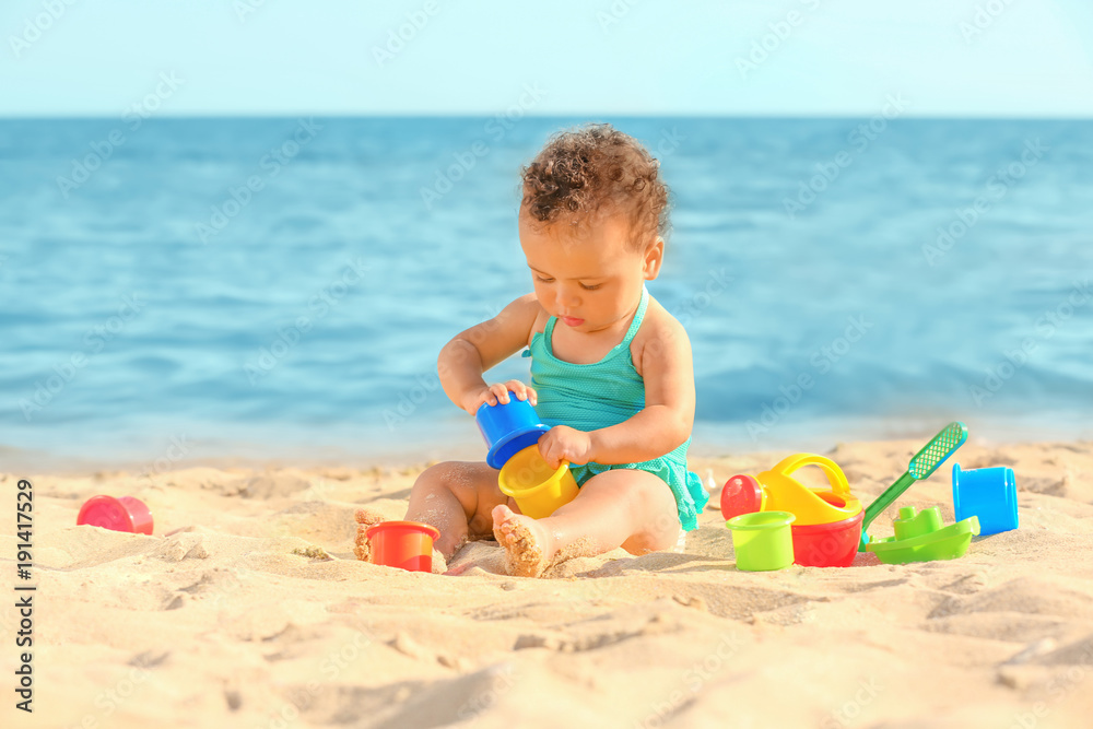 Little girl playing with sand toys on beach Little girl playing with sand toys on beach