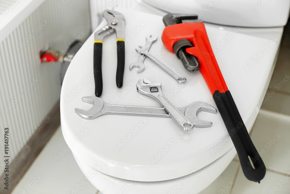 Plumber's tools on toilet seat lid Plumber's tools on toilet seat lid