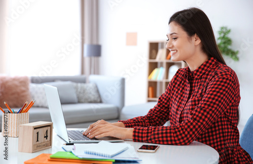 Young woman working in home...