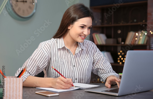 Young woman working in home...