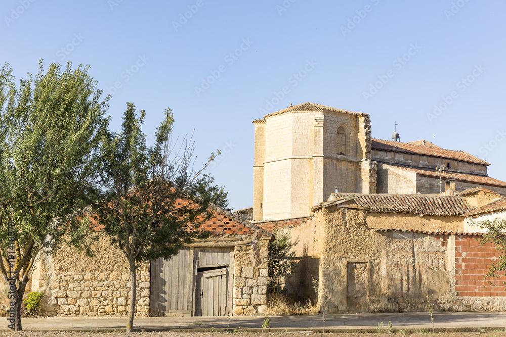 ancient houses made of clay and the church in Castrillo Mota de Judios village, province of Burgos, Spain