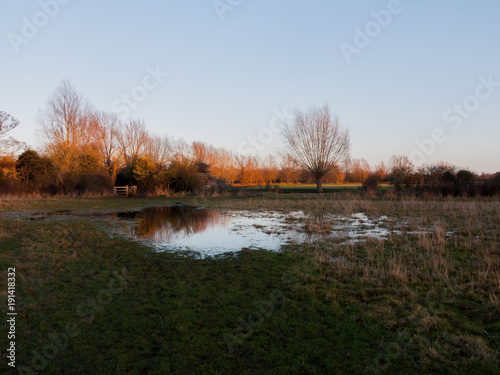 waterlogged country walkway white sky autumn field dedham photo