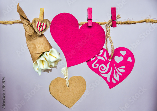 Red hearts with clothespins hanging on clothesline date, love Happy Valentines Day concept 