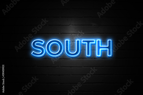 South neon Sign on brickwall