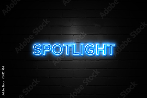 Spotlight neon Sign on brickwall