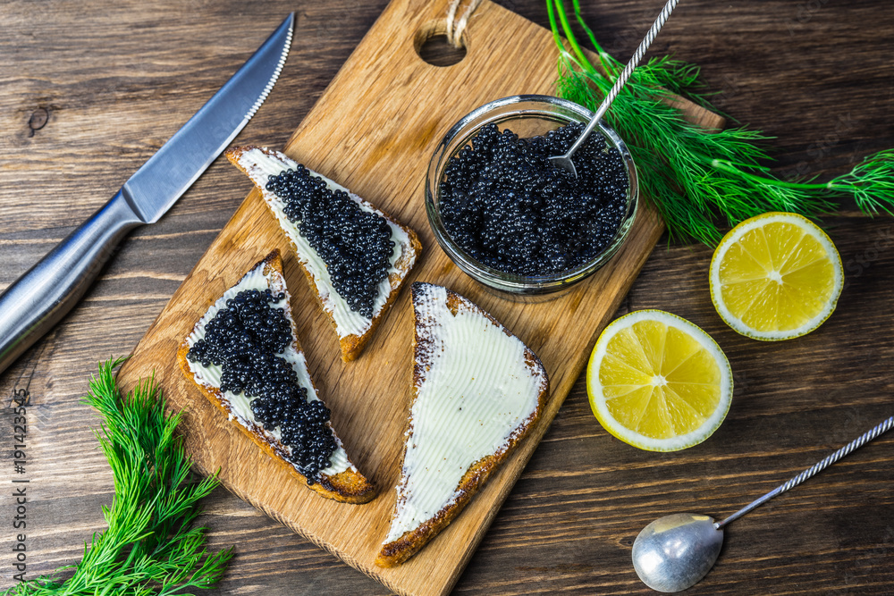 Black caviar on a sandwich. Put a silver spoon on the sandwich. Black caviar on a sandwich. Put a silver spoon on the sandwich.