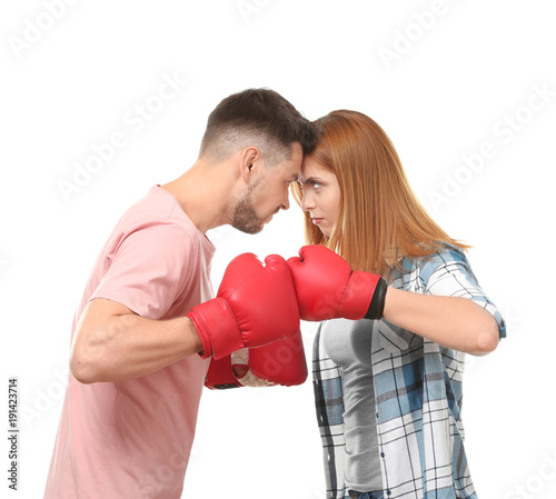 Angry couple in boxing gloves on white background