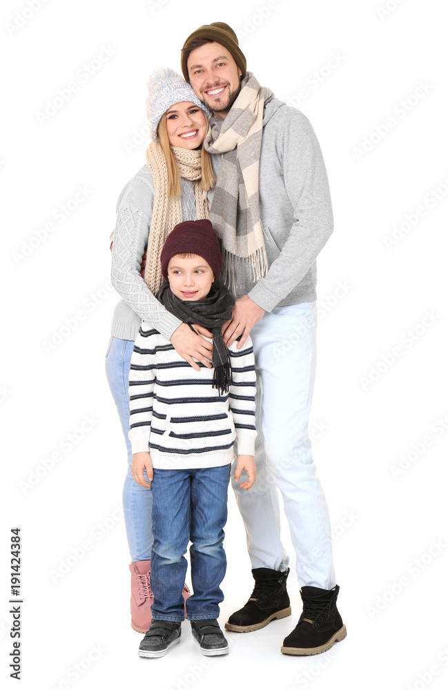 Happy family in warm clothing on white background. Ready for winter vacation Happy family in warm clothing on white background. Ready for winter vacation