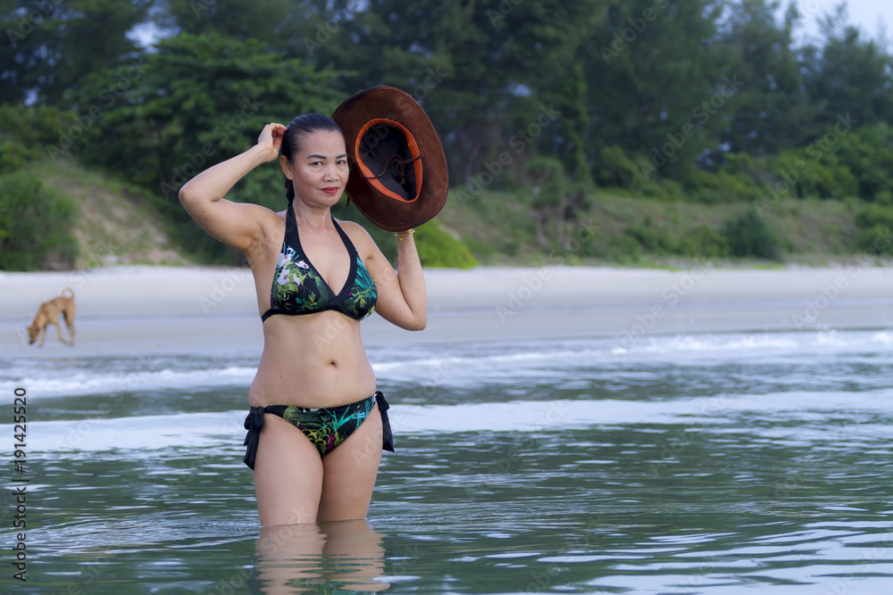 Woman show sexy bikini and hat on beach Stock Photo | Adobe Stock