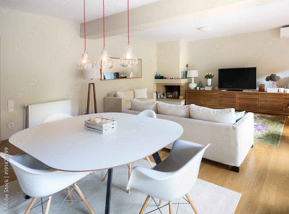 Dining - Living room with eiffel arm chairs and wooden cabinet. Dining - Living room with eiffel arm chairs and wooden cabinet.