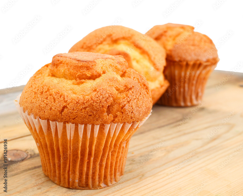 tasty muffin cake, isolated on wooden board tasty muffin cake, isolated on wooden board