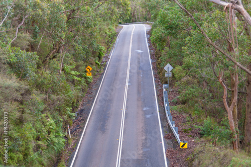 Aerial view of road turn with speed limit road sign