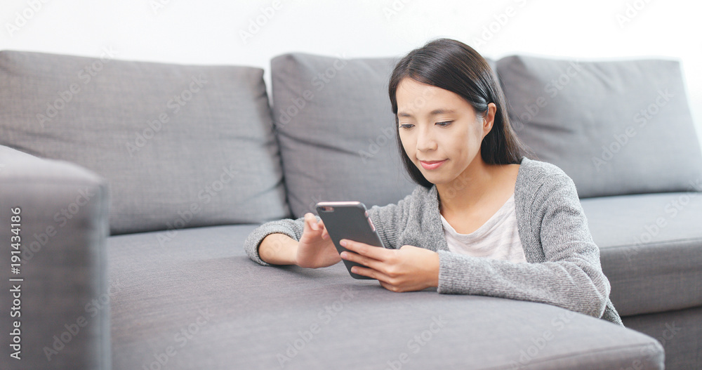 Woman using cellphone at home