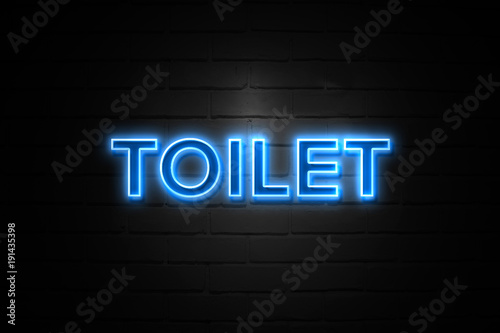 Toilet neon Sign on brickwall