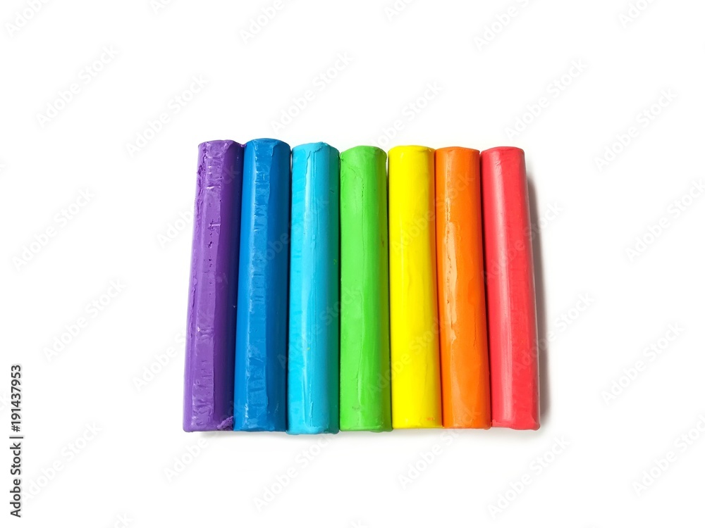 Colorful plasticine clay sticks put together on white background, multicolored line dough Colorful plasticine clay sticks put together on white background, multicolored line dough