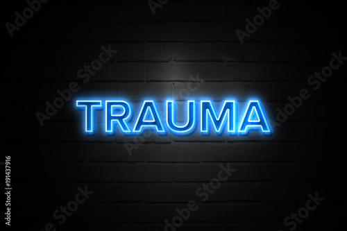 Trauma neon Sign on brickwall