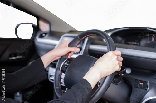 Hand holding steering wheel in modern private car with blank windshield © Mumemories