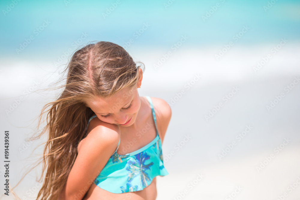 Little girl at beach during caribbean vacation. Portrait of beautiful kid background blue sky Little girl at beach during caribbean vacation. Portrait of beautiful kid background blue sky