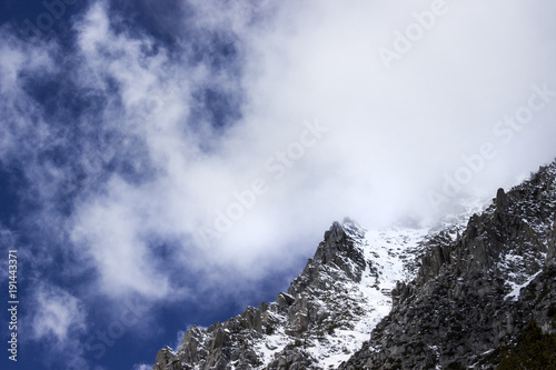 Steep Sierra Mountain Peak in the Clouds with Snow