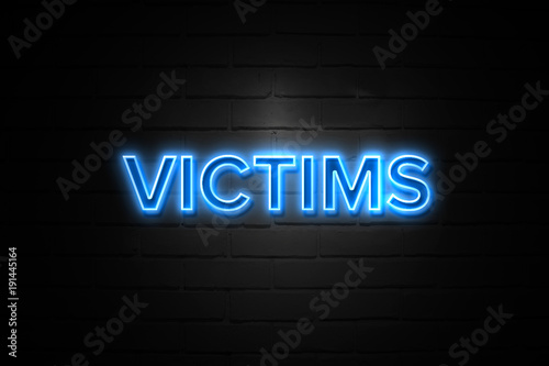 Victims neon Sign on brickwall