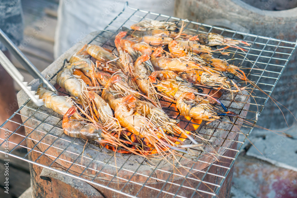 Grilled prawns,Grilled shrimp on grill with stove in background...